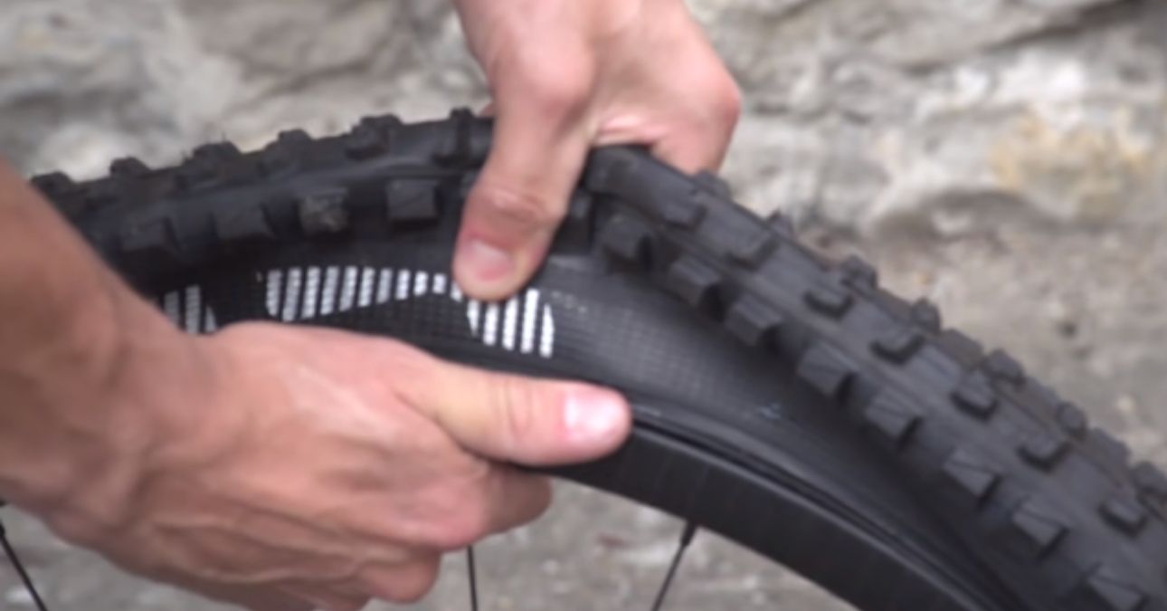 Using hands to push down Fat Bike Tire